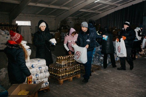Mission Without Borders staff and volunteers prepare emergency food parcels for Eastern Europe 