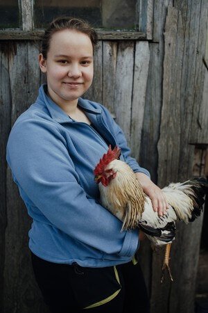 Lyudmyla, 17, helps her mother and family tend to the animals they raise for food and income in Western Ukraine after being displaced by the war and losing her father. Summer Camps are an escape of the stress and worry for her, as well as a place to heal.